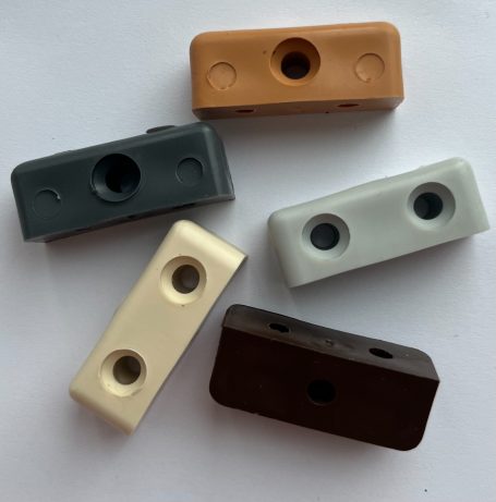 Five rectangular plastic clips in brown, beige, grey, cream, and light green.